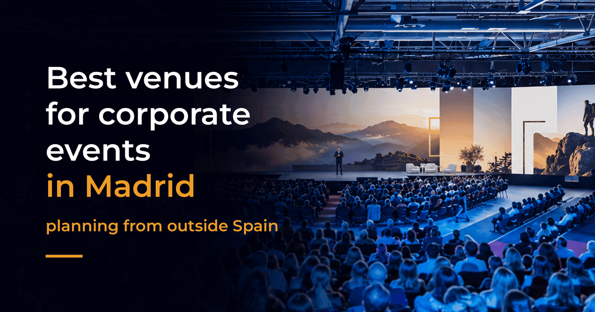 A packed auditorium during a corporate conference, with a speaker on stage in front of panoramic screens showing mountains at sunset A packed auditorium during a corporate conference, with a speaker on stage in front of panoramic screens showing mountains at sunset